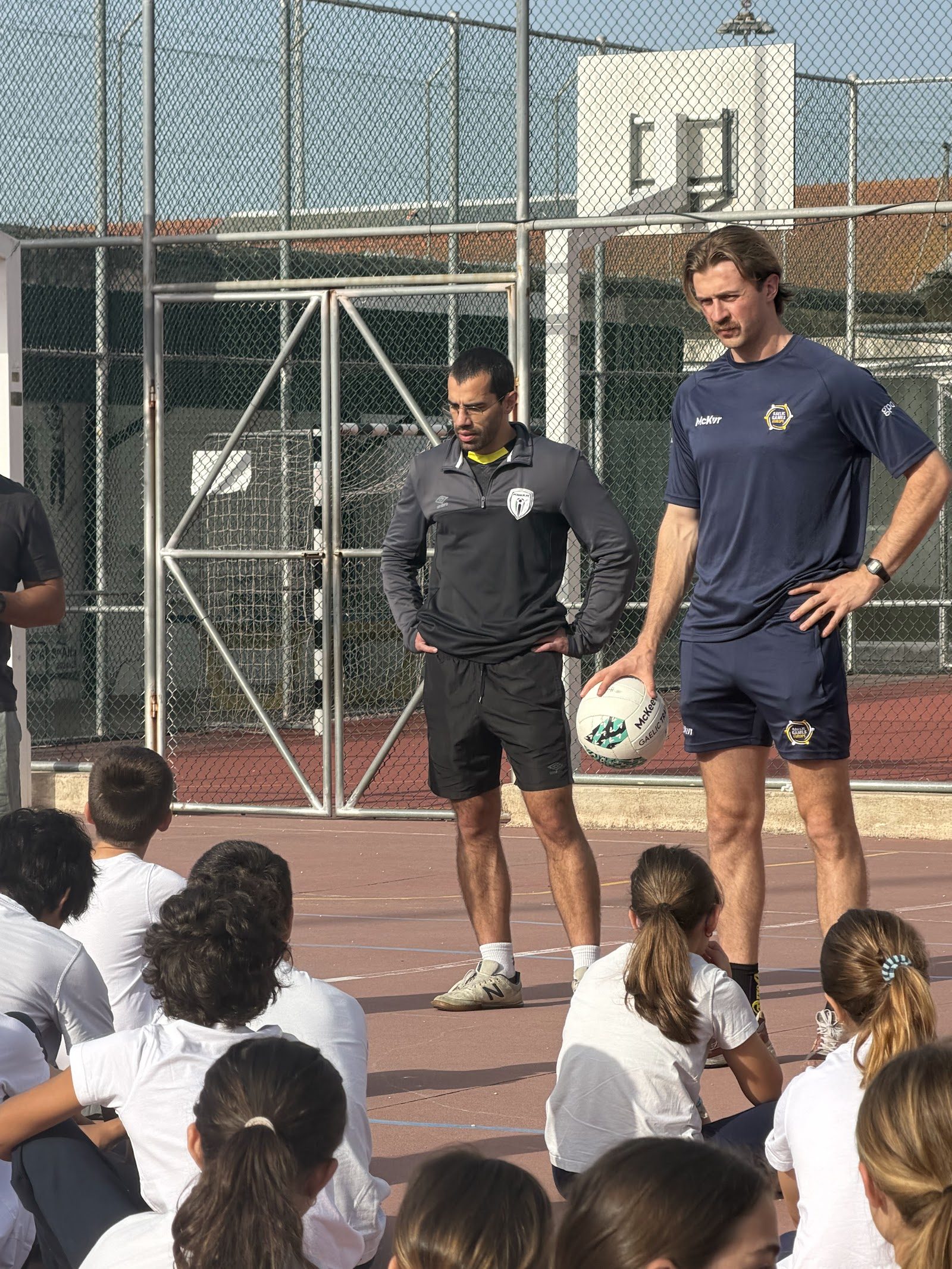 Coaches introducing Gaelic football to children at a GAA Portugal juniors session